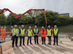 Project partners gather at the construction site